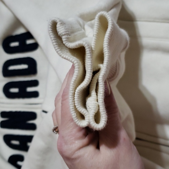 Attraction zip up jacket says Canada in front. Cream in color size lg - Picture 8 of 9